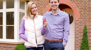 Your essential guide to buying a first home couple smiling keys